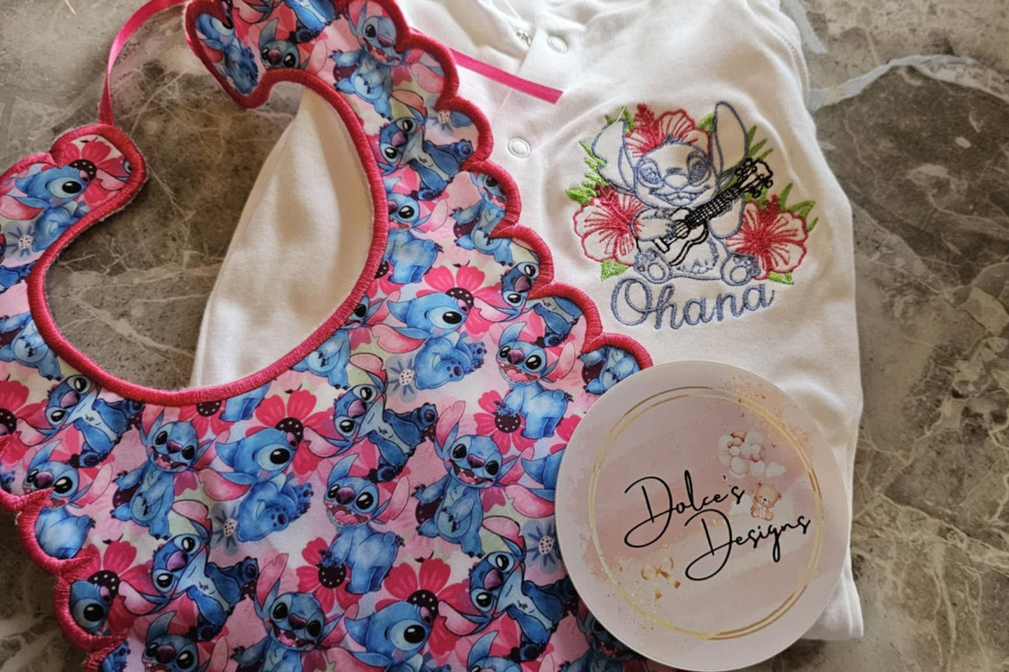 Children's bib with cartoon character design on a marble surface