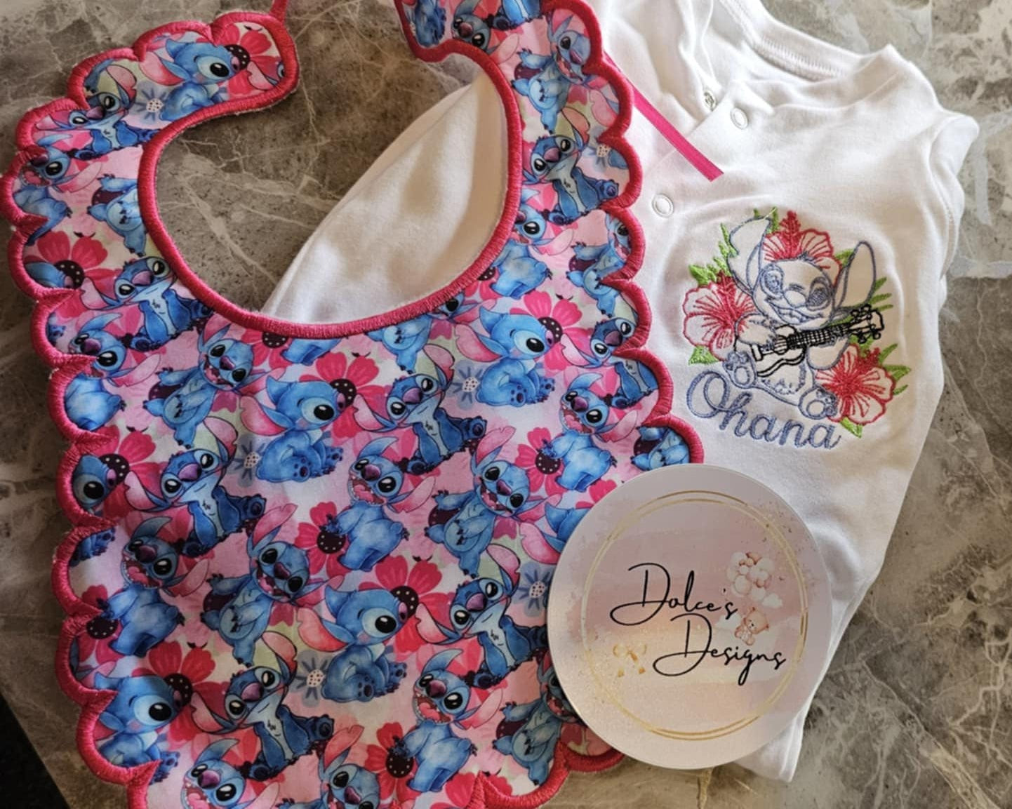 Colorful baby bib with cartoon design on a stone surface